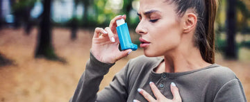 A woman using an inhaler