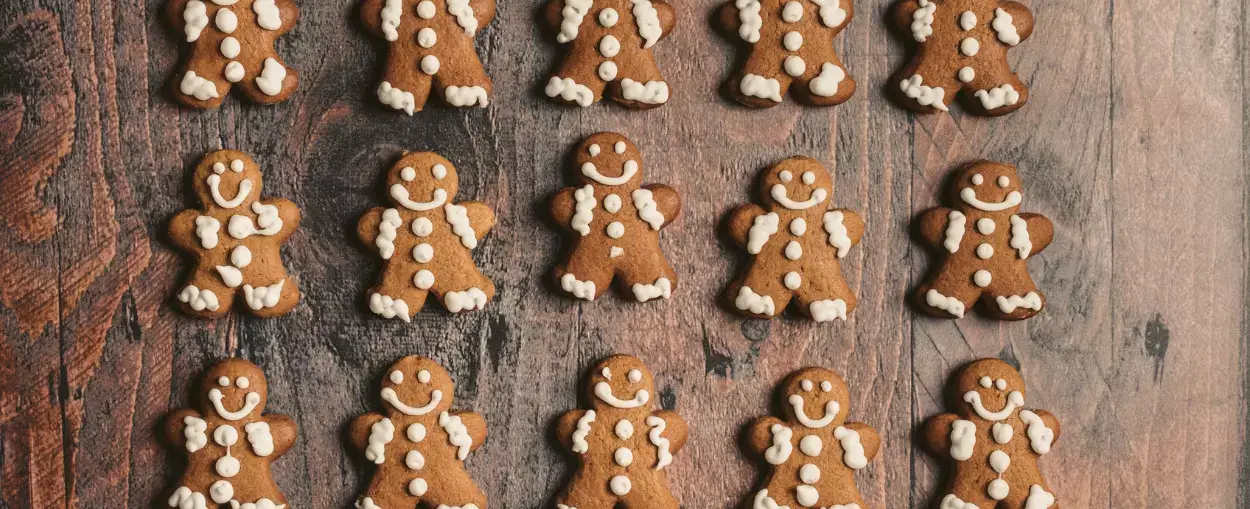 A group of gingerbread men on a wooden table